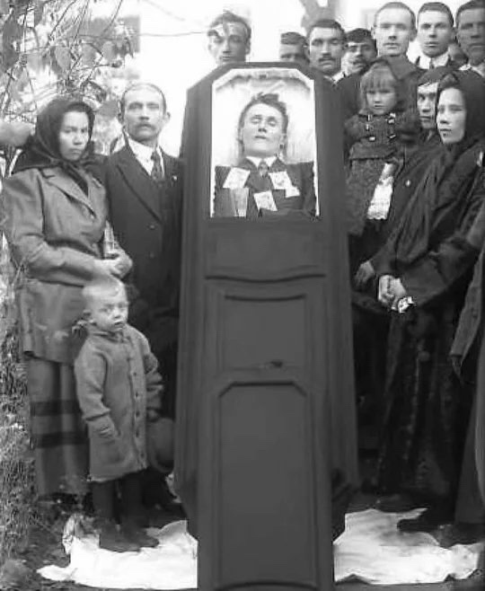 A somber family portrait from the 19th century funeral.