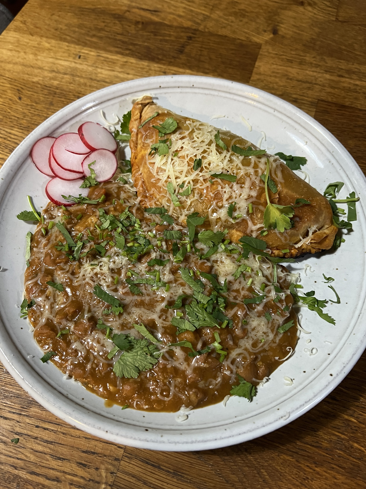 Delicious Empanada filled with chorizo, potatoes, and beans