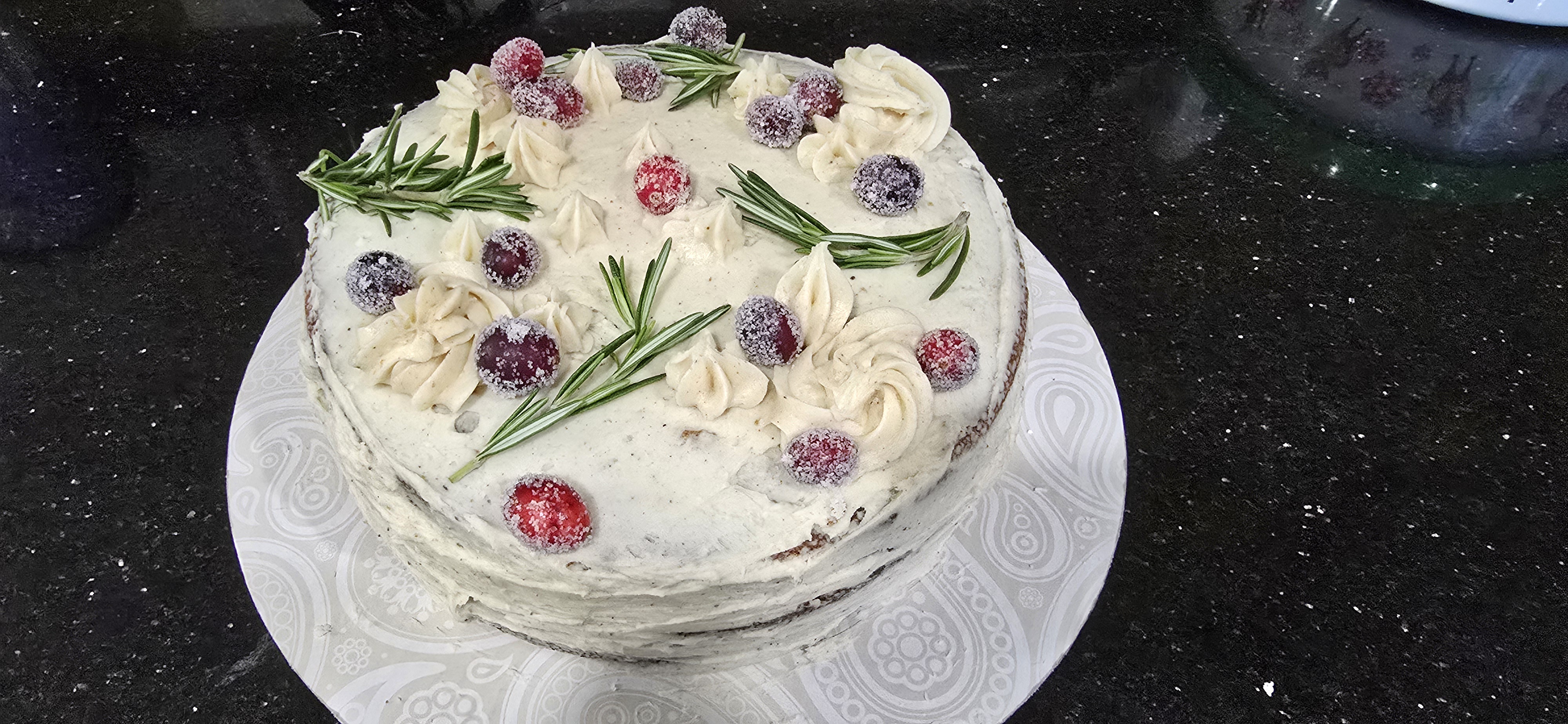 Indulge in This Homemade Spice Cake Topped with Eggnog Frosting and Candied Cranberries!
