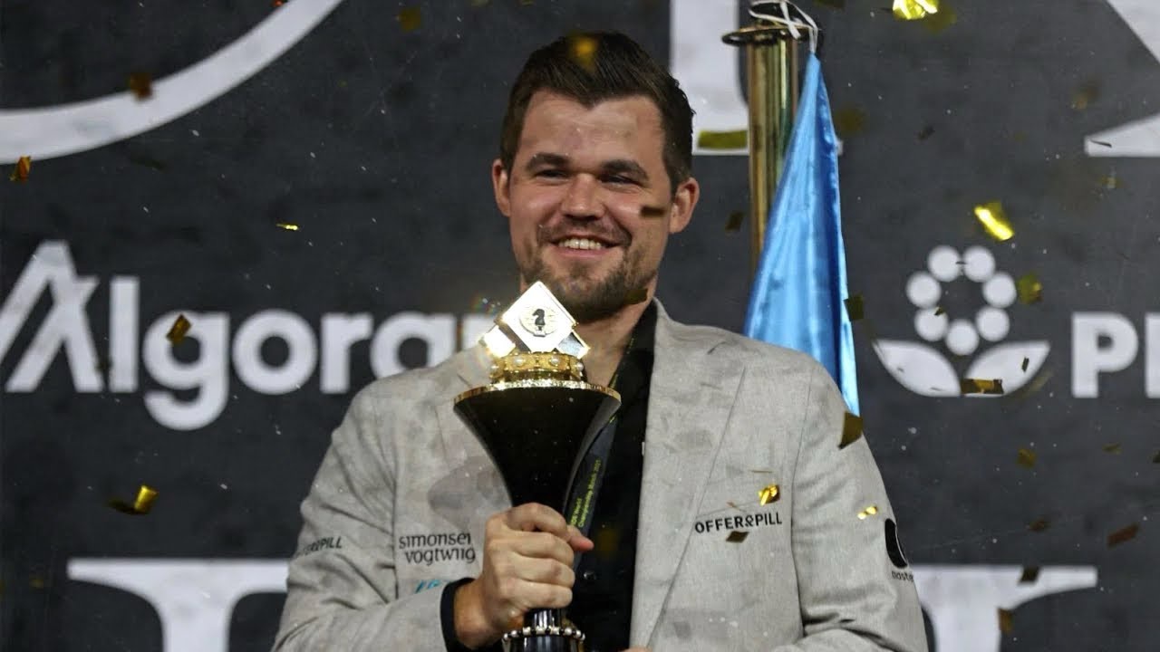 Magnus Carlsen proudly accepts his World Championship trophy