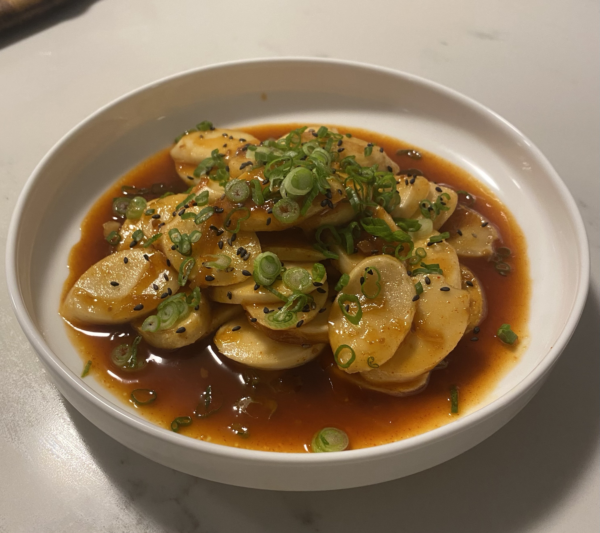 Indulging in the spicy goodness of Tteokbokki (Spicy Rice Cakes)