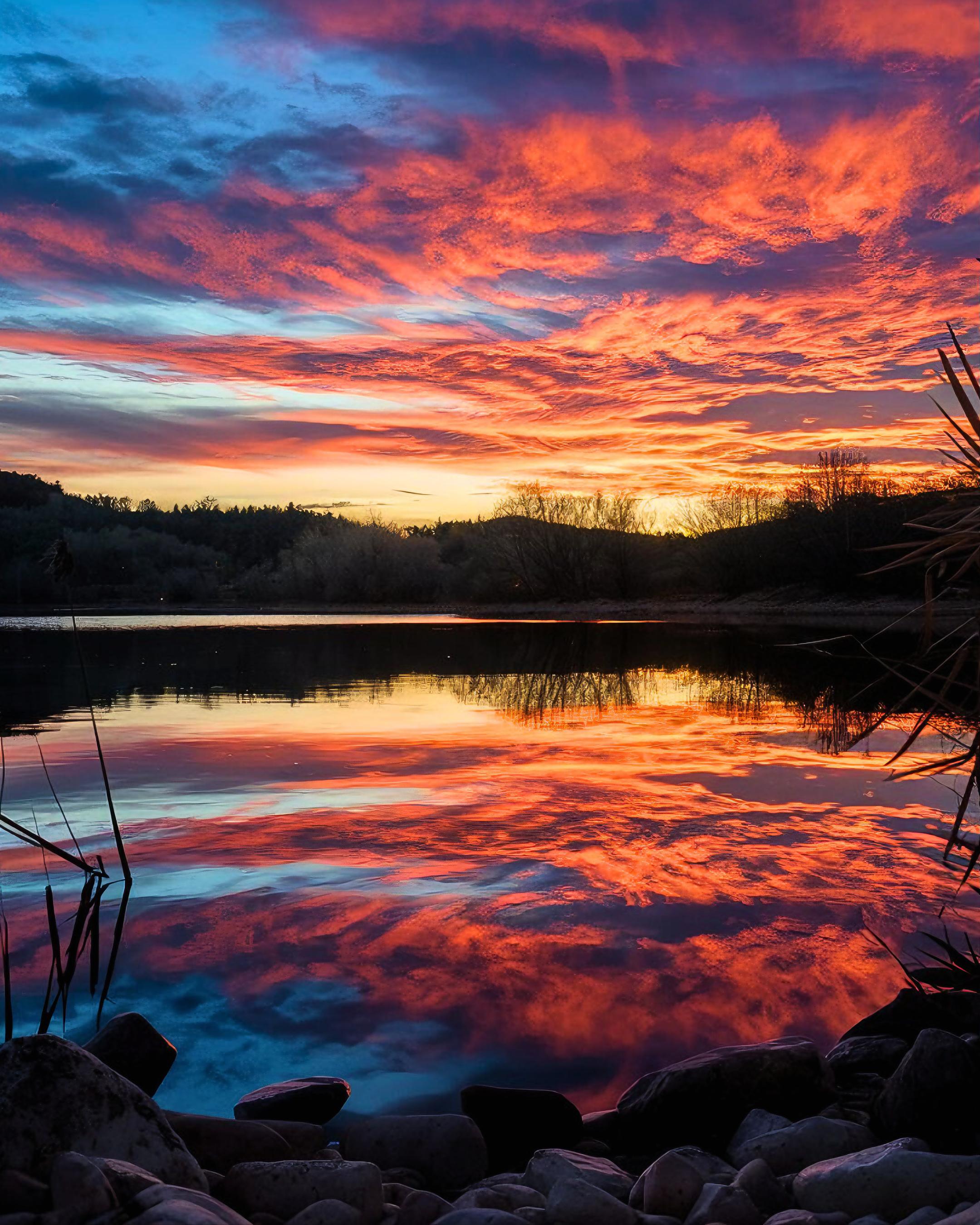 Witness the Stunning Contrast of Fiery Skies and Calm Waters