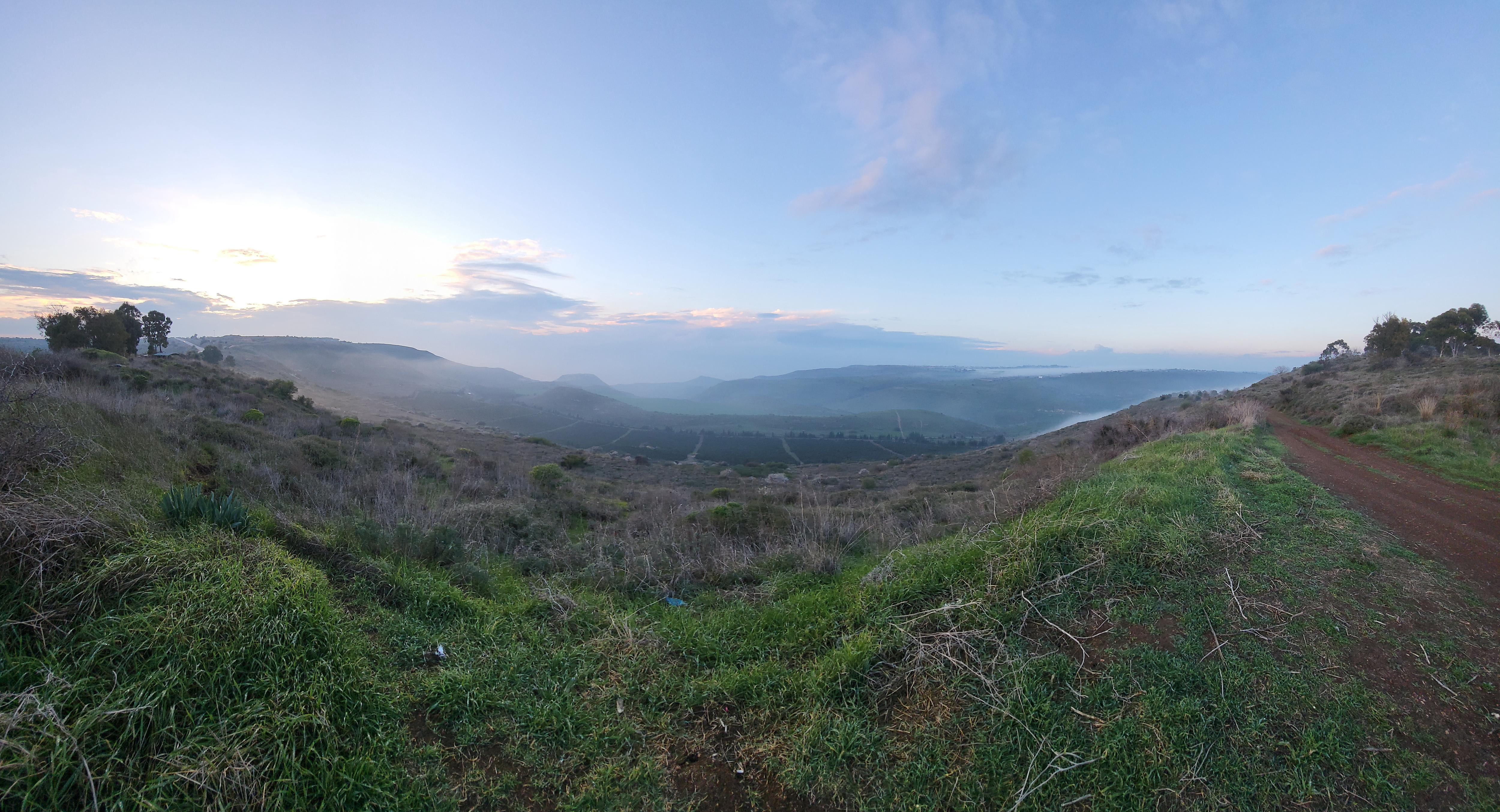 As the sun sets, a mystical mist blankets the hills