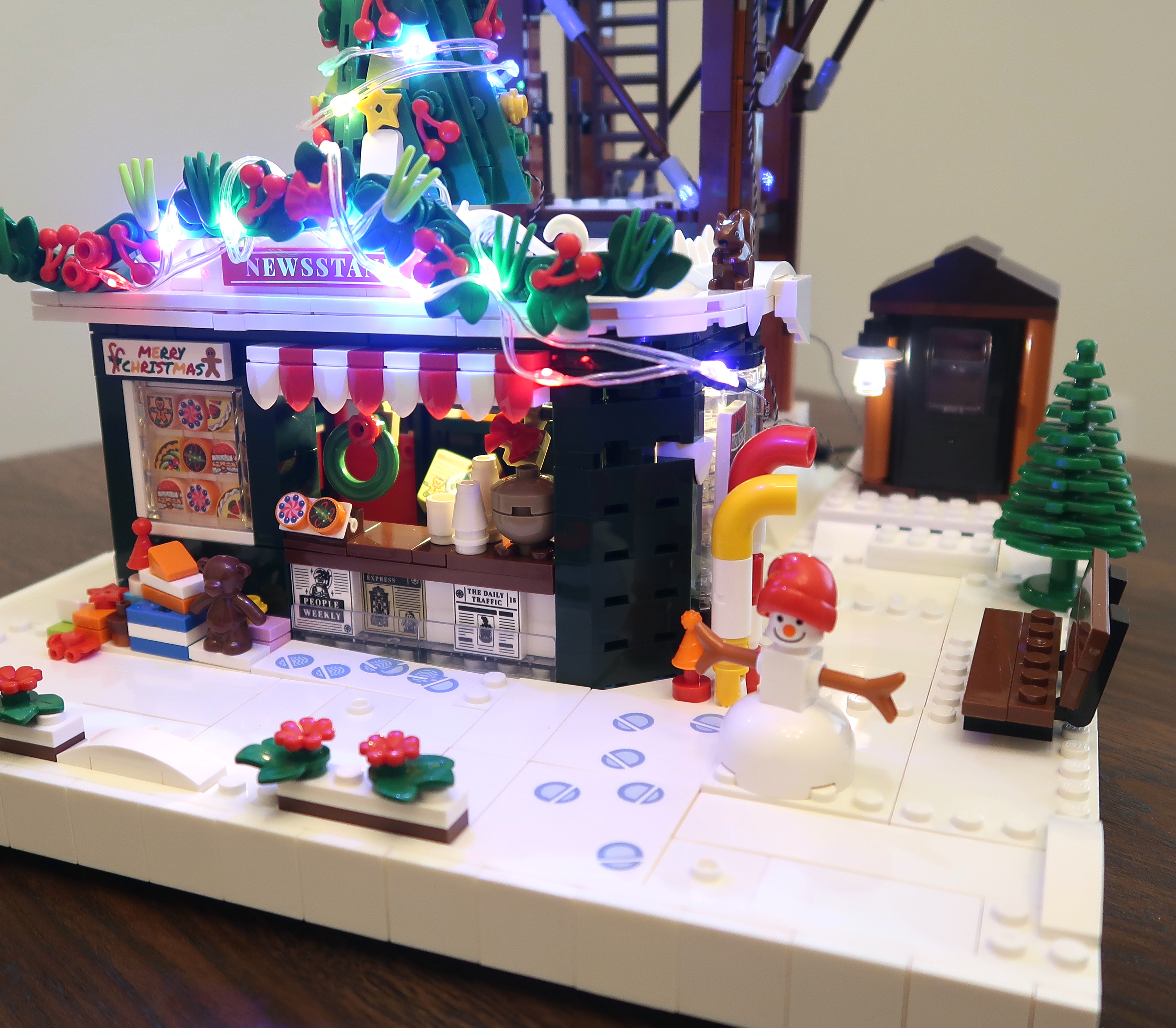 Check out this Lego-style Christmas newsstand, lookout tower, and outhouse combo!
