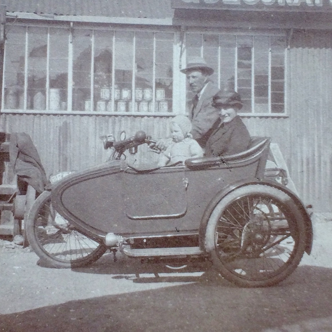 My great-grandfather riding a motorcycle with my great-grandmother and grandmother