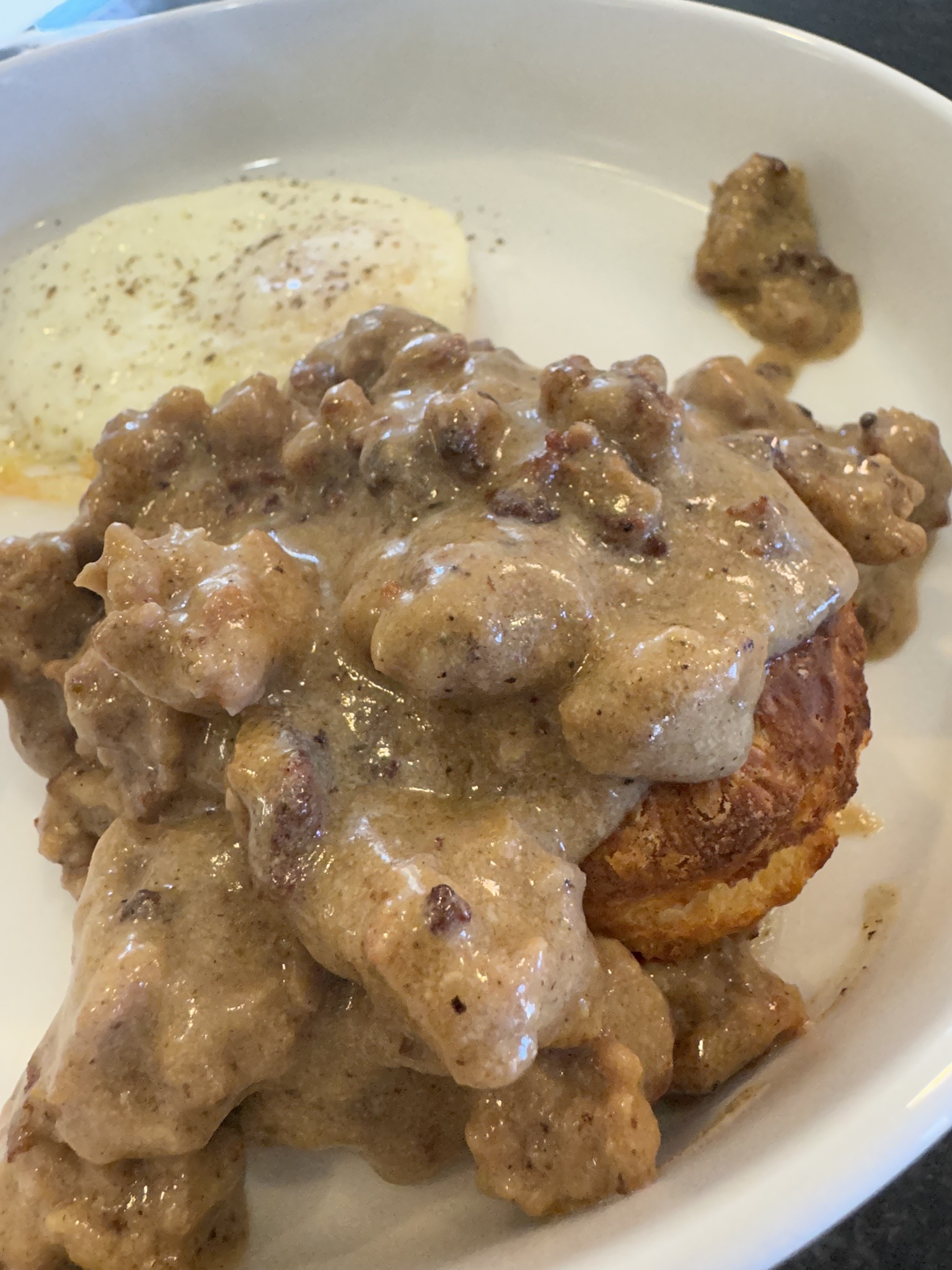 Delicious homemade thyme biscuits served with savory sausage gravy.