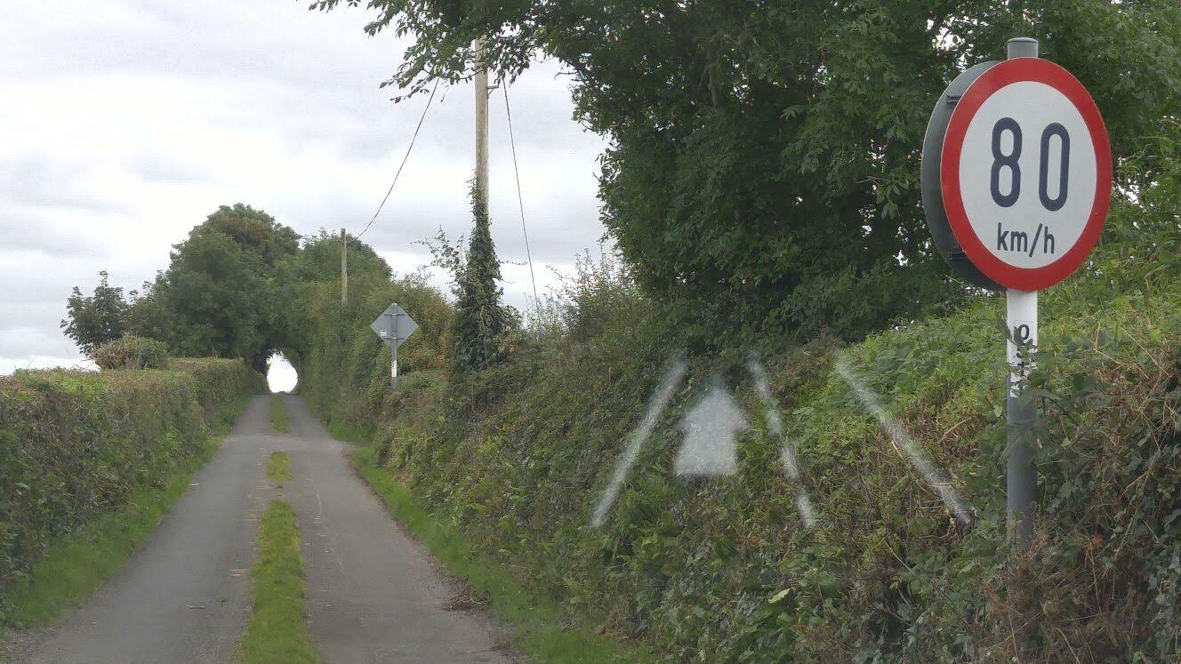 In Ireland, speed limits feel more like a challenge on this narrow gravel road at 80 km/h!