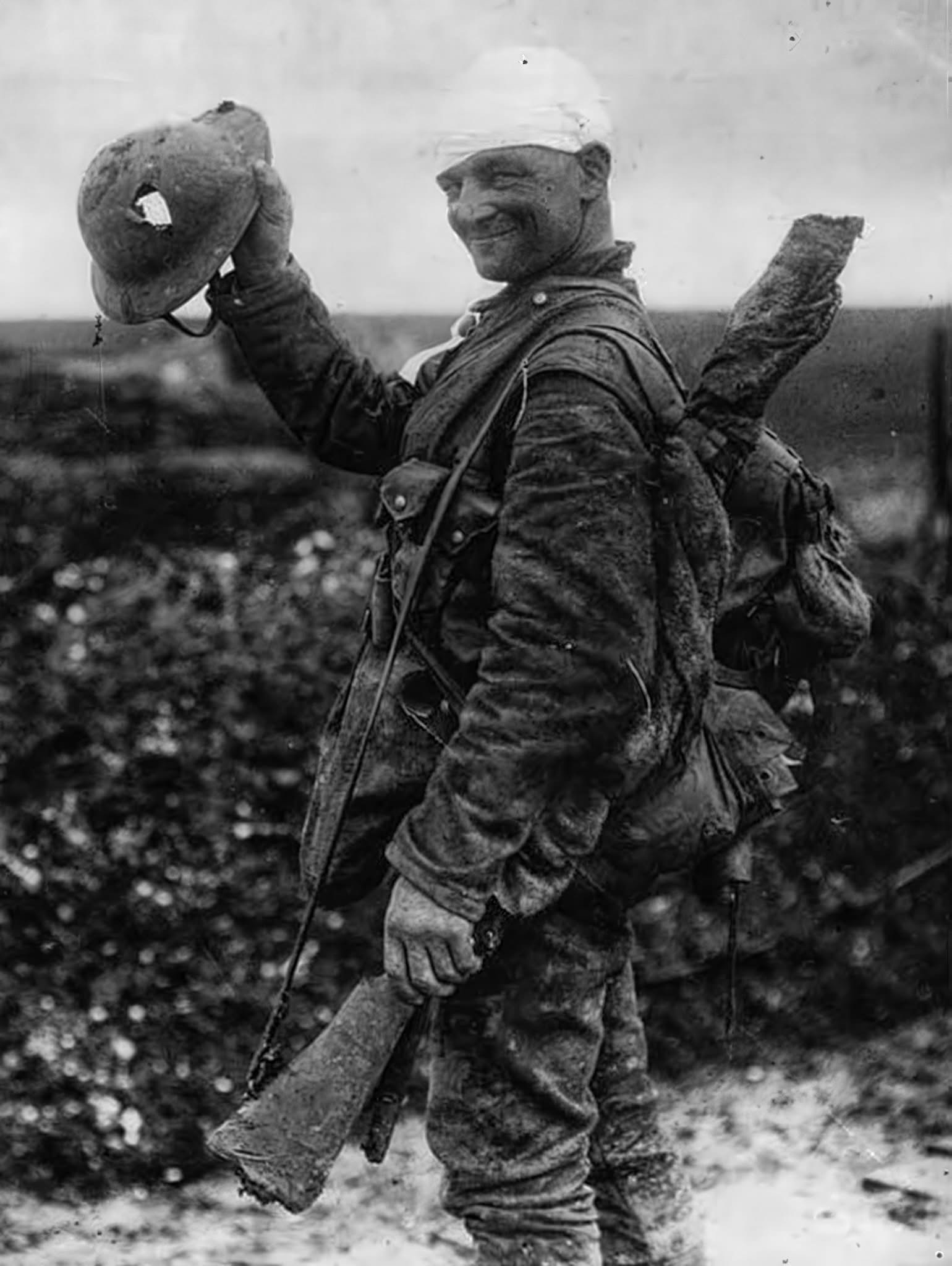 A Lucky British Soldier Proudly Displays His War-Damaged Helmet from 1917