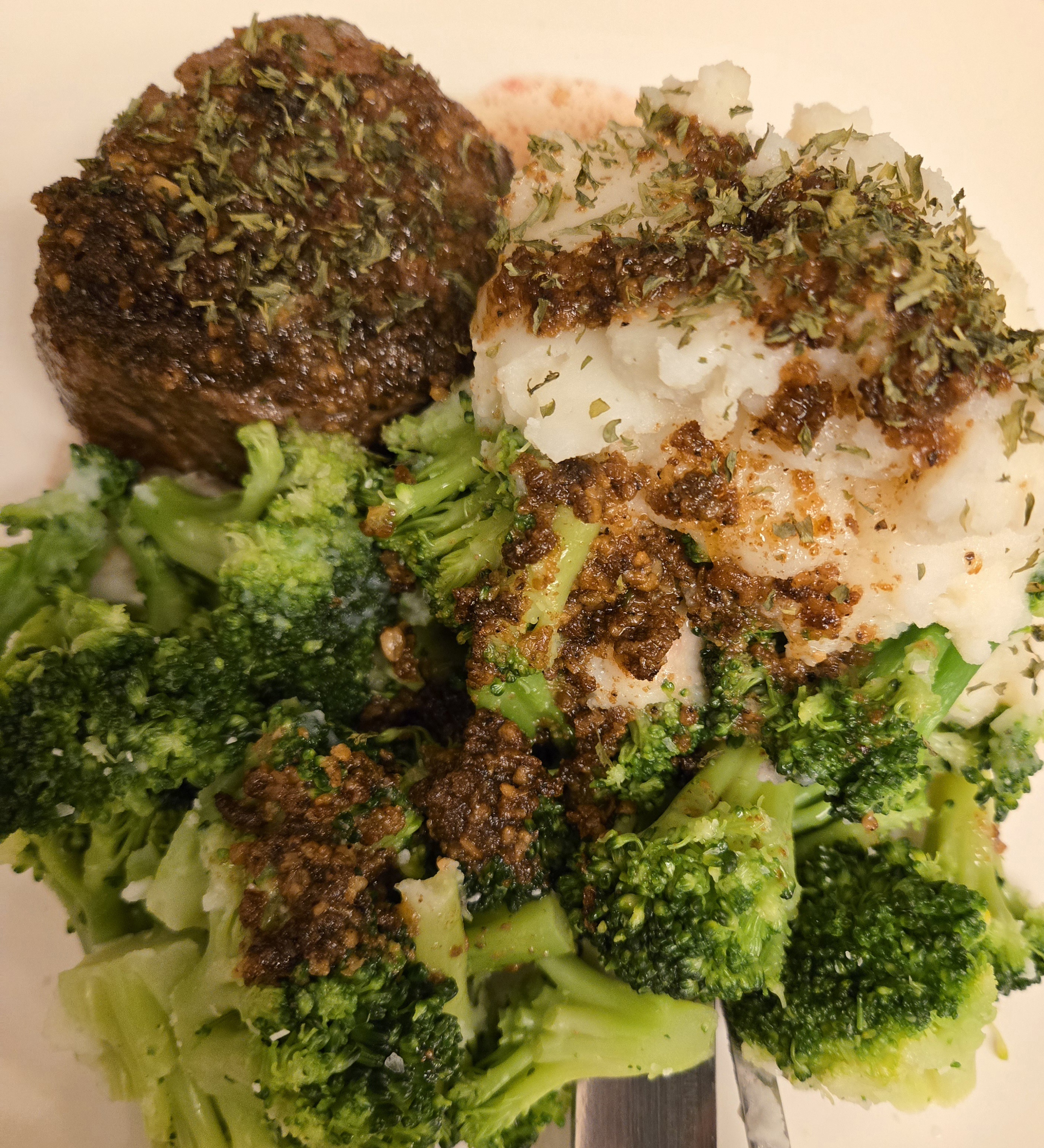 Indulging in a delicious sirloin with creamy mashed potatoes and fresh broccoli for dinner