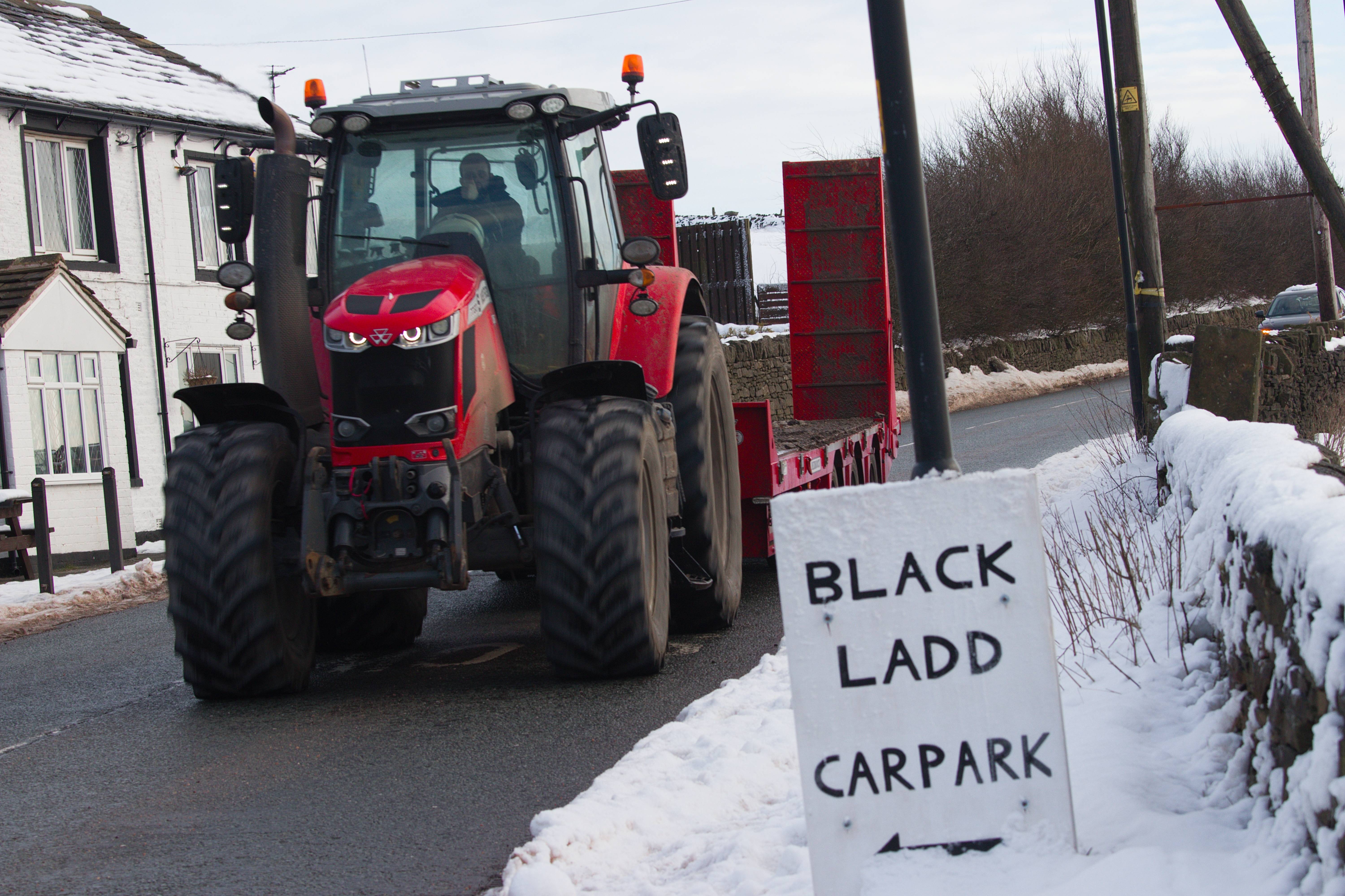 A tractor cruising down the streets of Shaw, UK