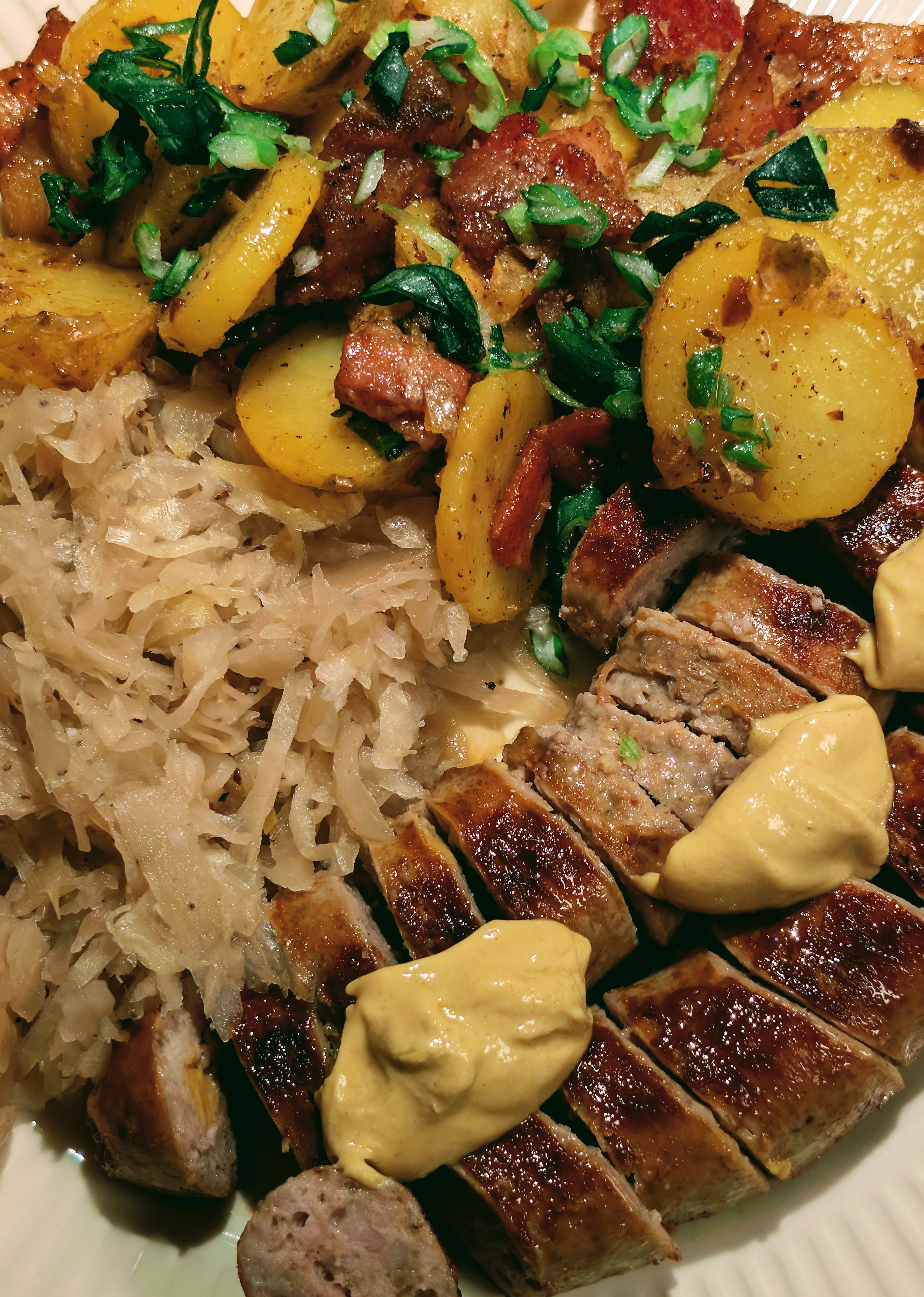 Delicious Trio: Brats, Sauerkraut, and Potato Salad