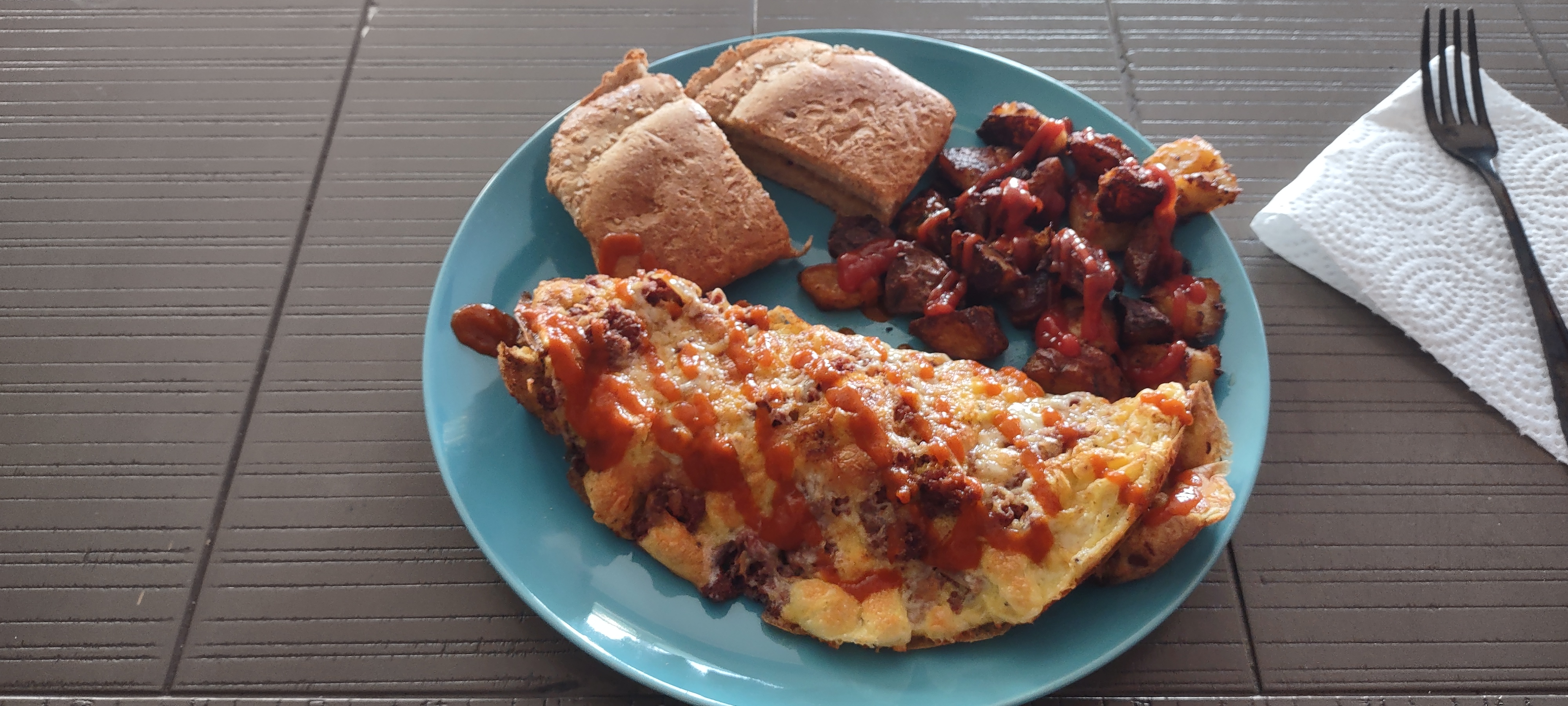 Indulge in a Corned Beef Omelet with Crunchy Paprika Potatoes and Extra Cheese