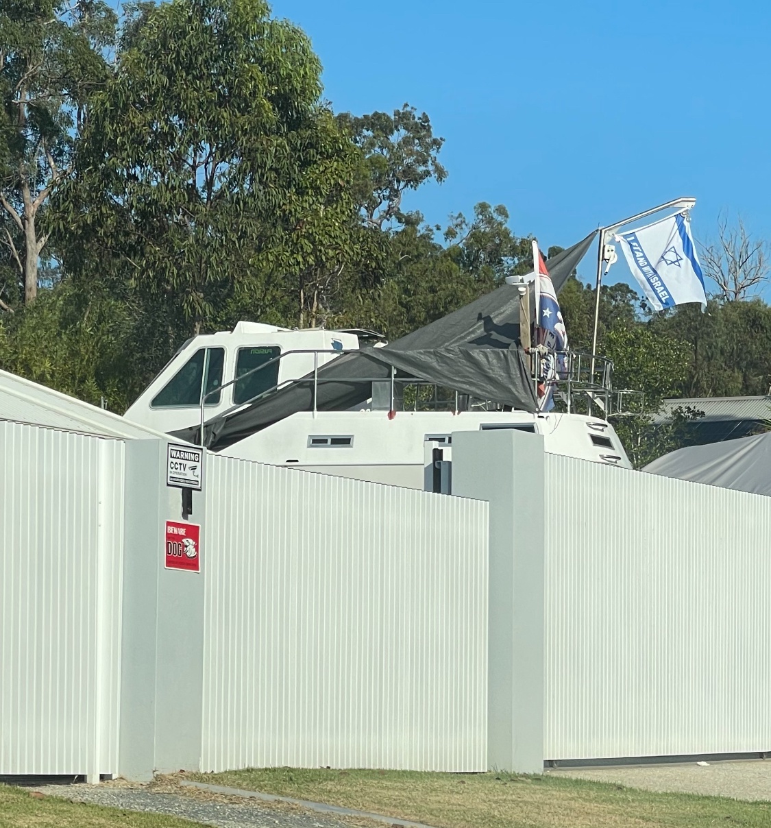 It’s Unusual to See Trump 2024 and Stand with Israel Flags on a Boat in the Aussie Suburbs