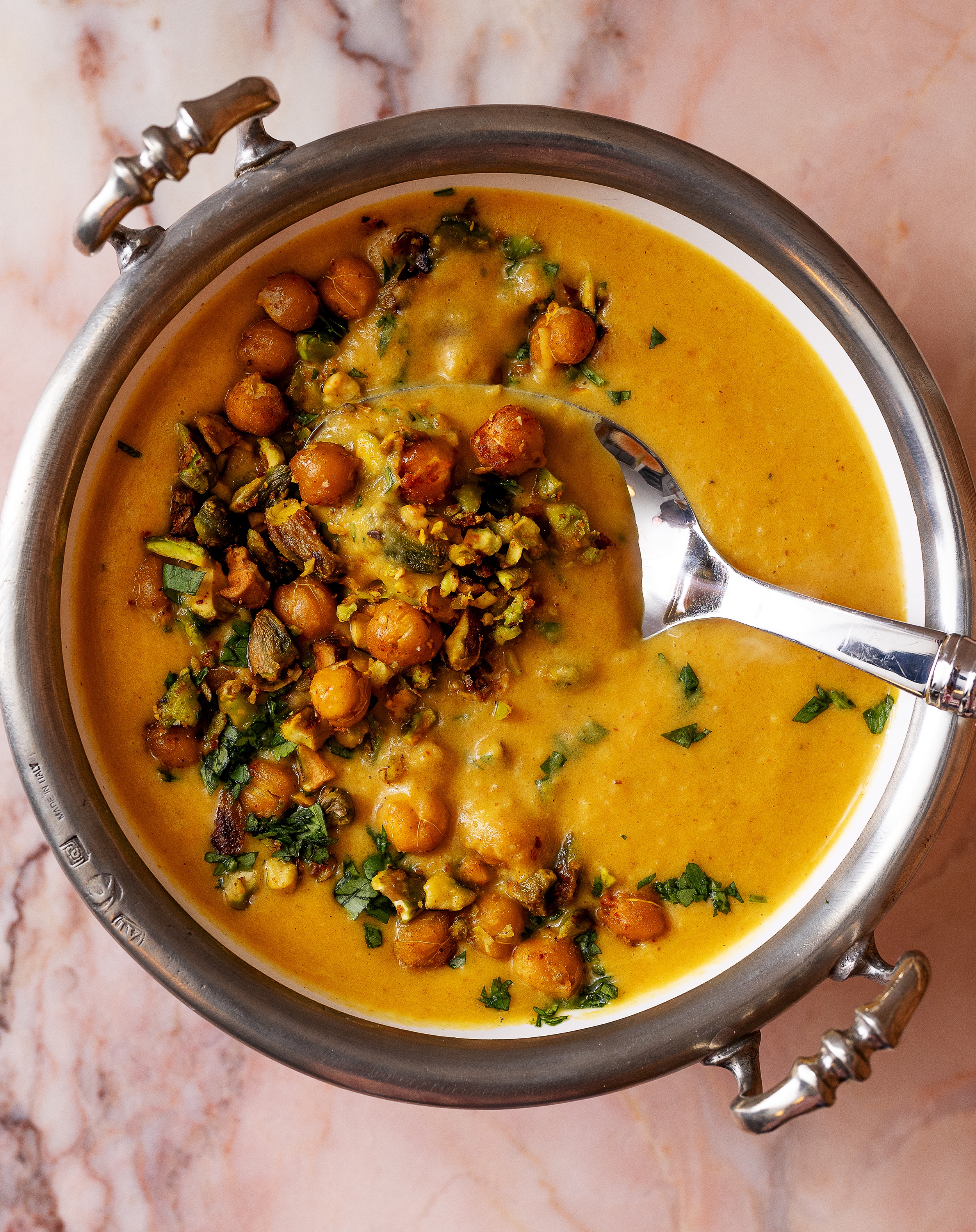 Delicious Curry Butternut Squash Soup topped with Crispy Chickpeas and Pistachios - A Must-Try Recipe!