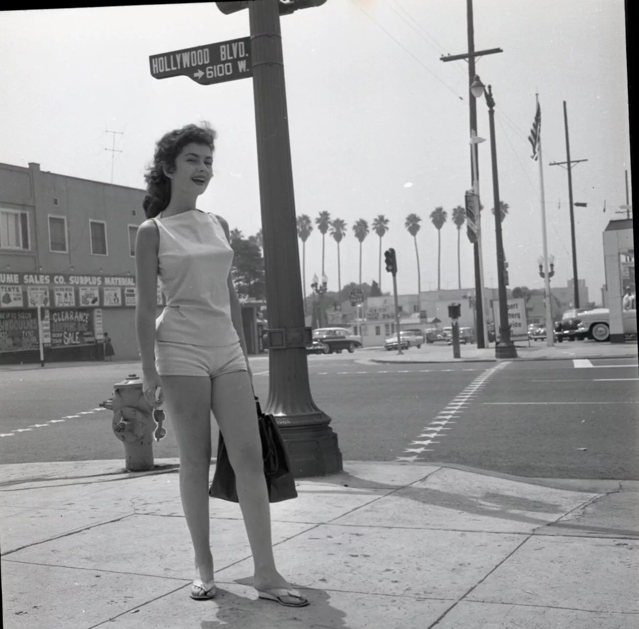 A woman strolling down the streets of LA in the 1950s.