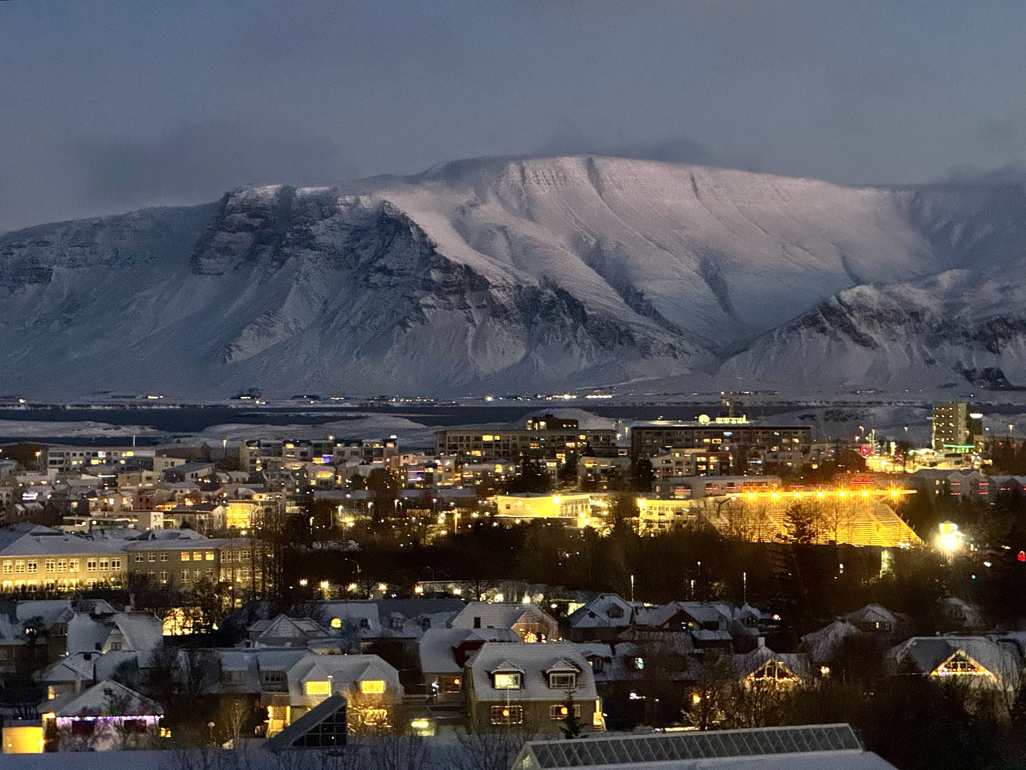Witnessing the breathtaking mountain views outside my Reykjavik hotel at sunrise, noon, and sunset—all in just four hours!