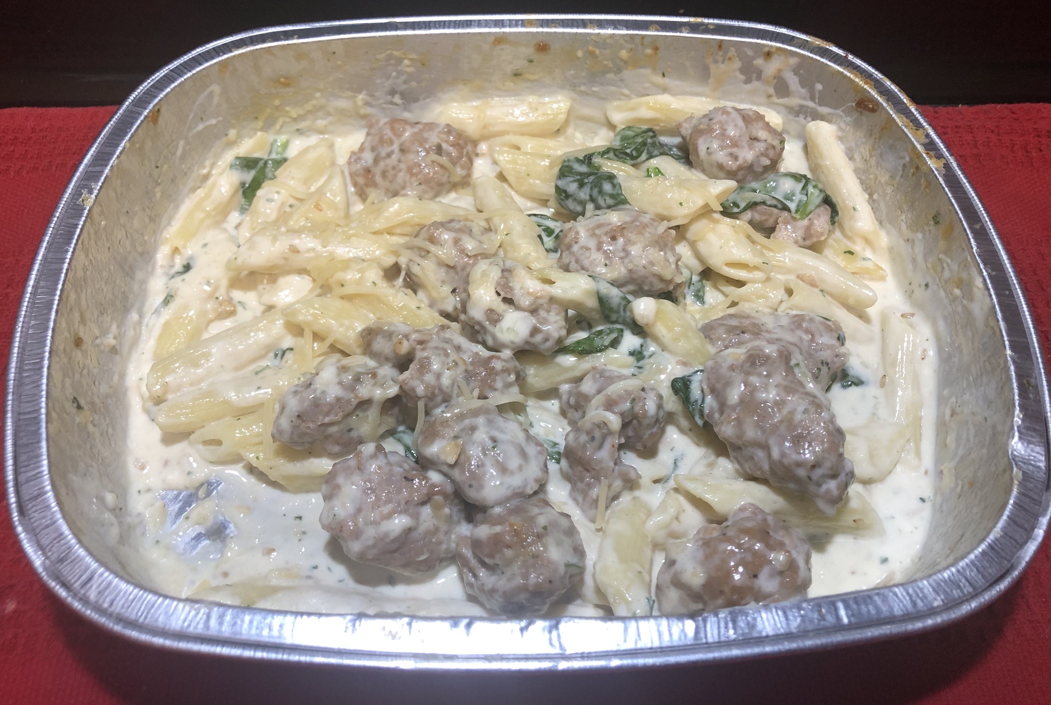 Delicious Italian Sausage Penne in Creamy Spinach Sauce Topped with Parmesan