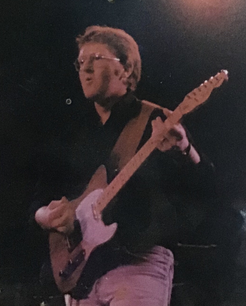 Decades apart, yet still rocking the black shirt, jeans, and a Telecaster.
