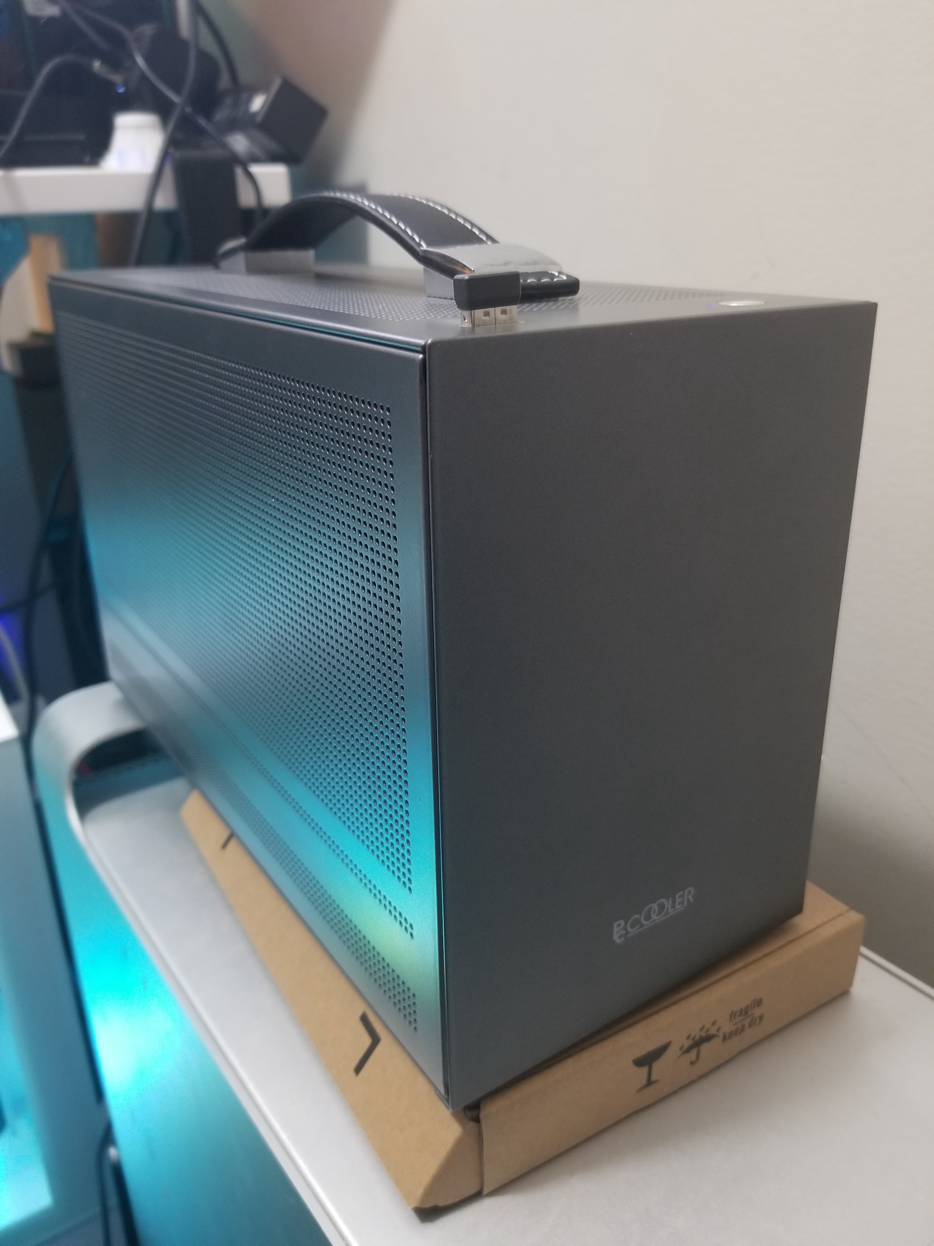 Building a compact powerhouse: PC Cooler Mini i100 SFF Mini ITX setup.