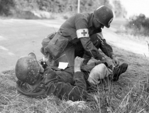1944, France: A US Medic Aiding a Wounded SS Soldier