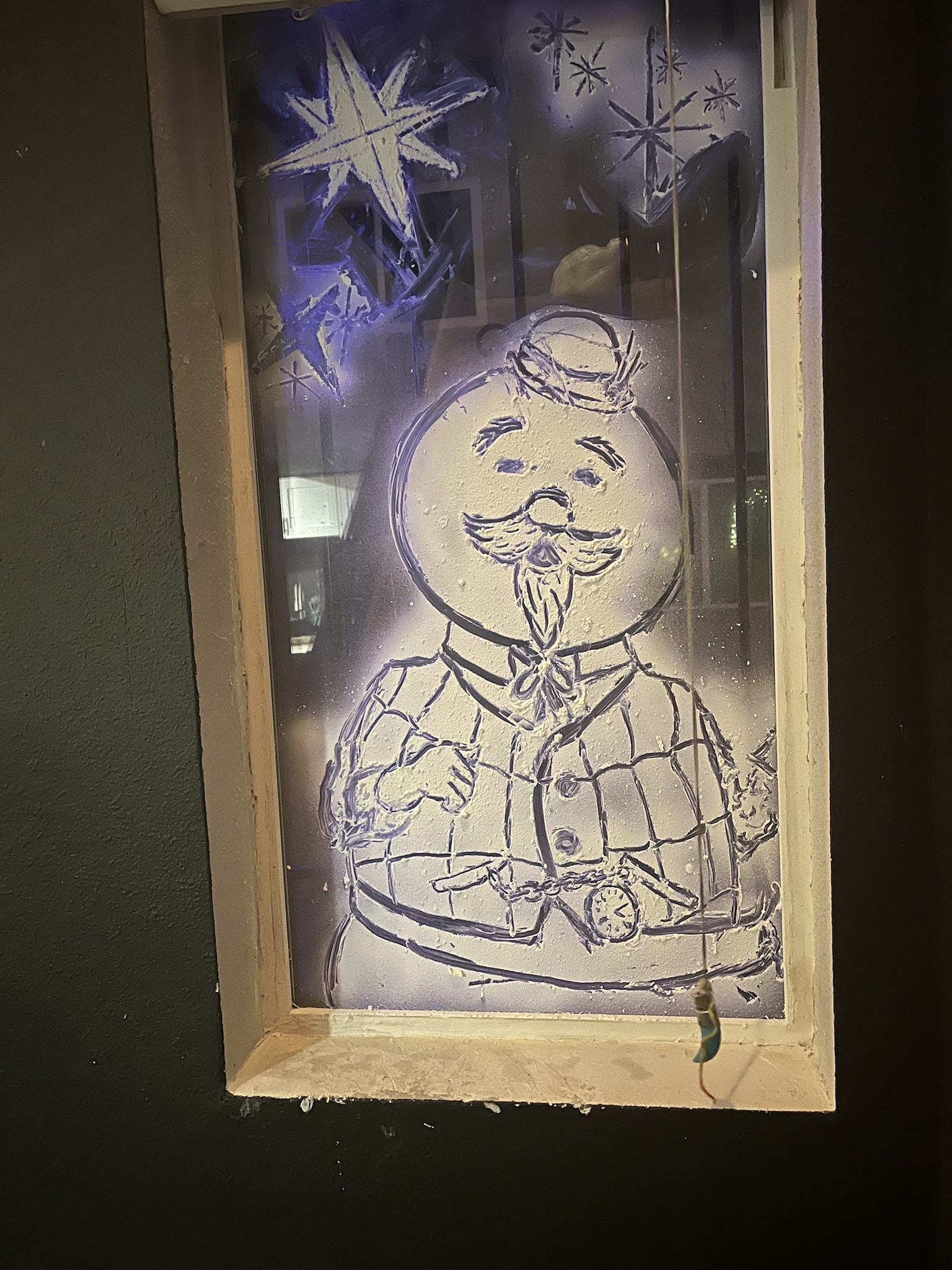Creative window art featuring Sam the snowman