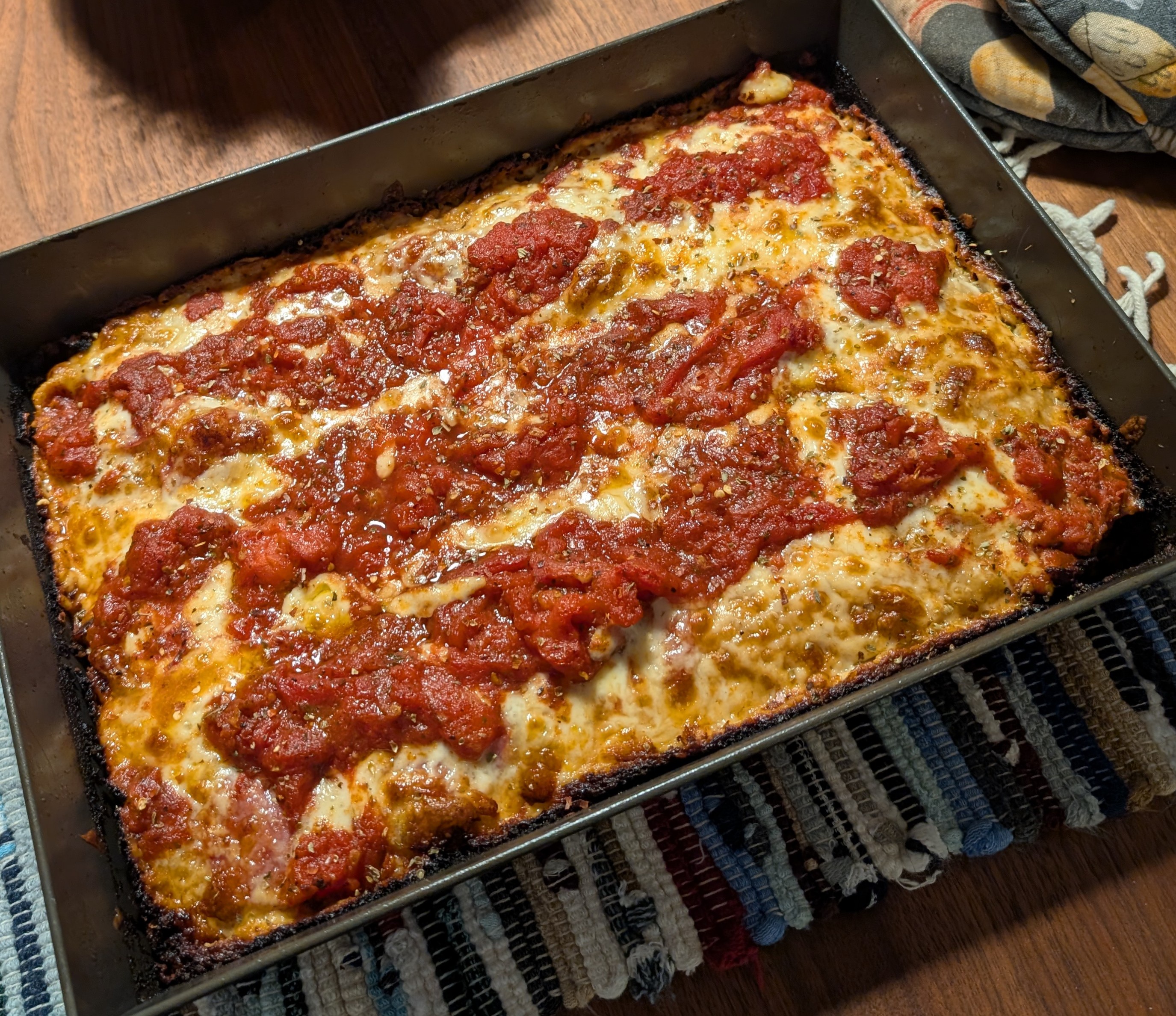 Delicious homemade Detroit-style pizza topped with fresh homegrown romas